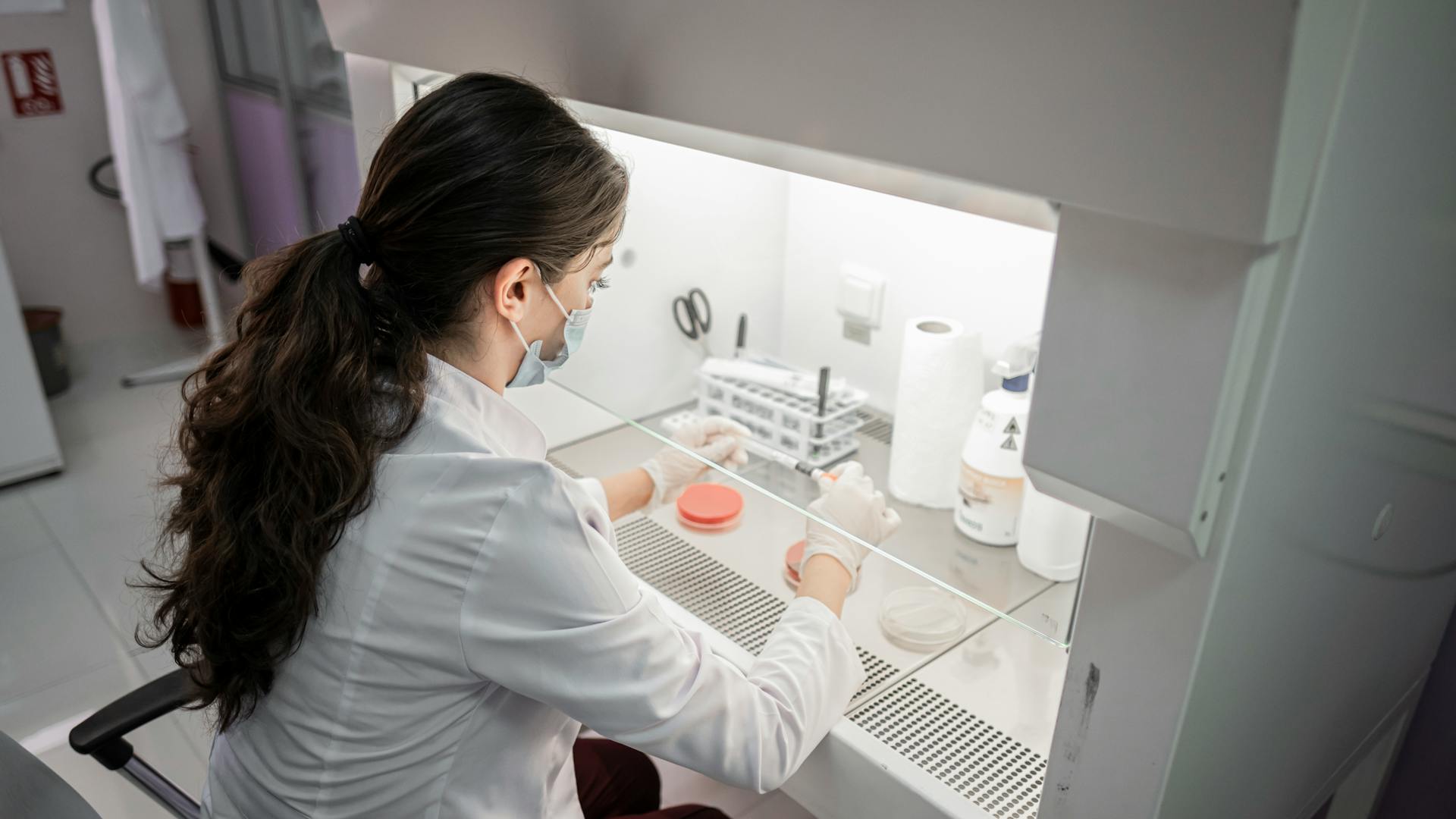 A female scientist conducts research in a modern laboratory setting in Baku, Azerbaijan.