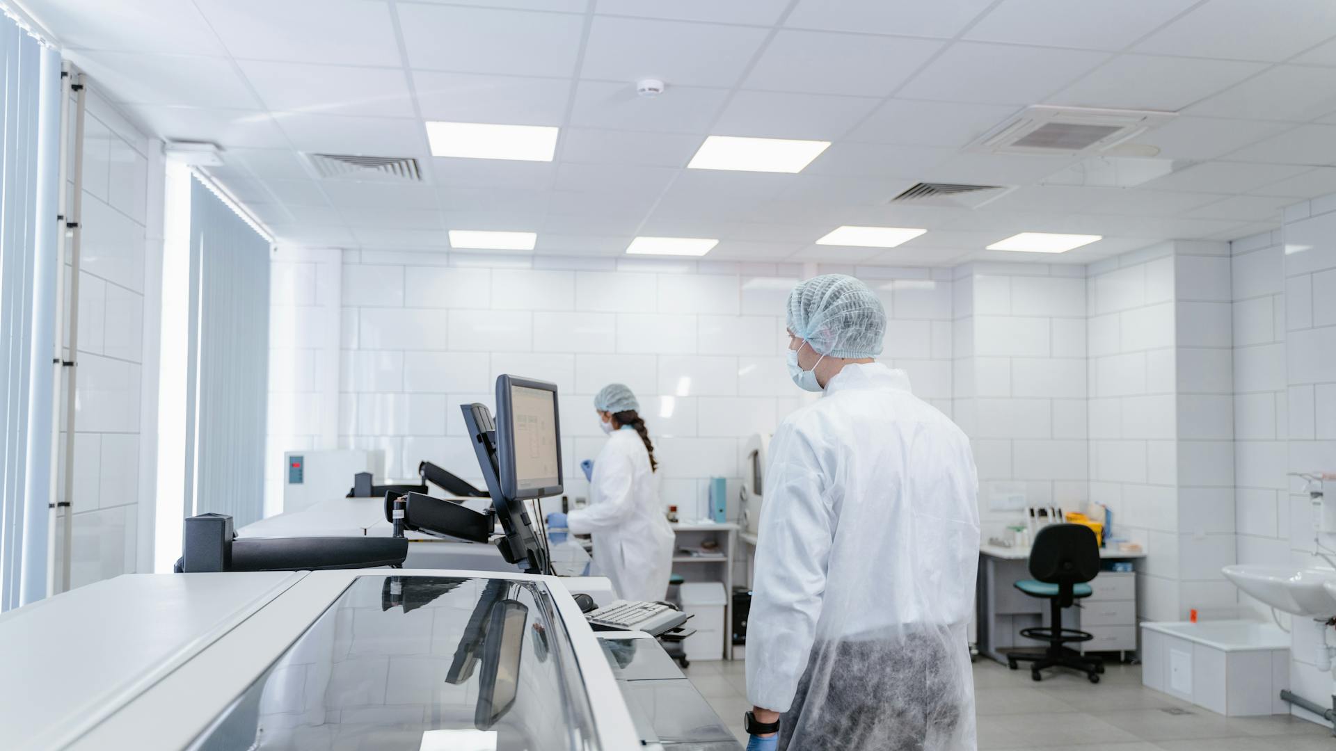 Laboratory professionals conducting research in a modern, well-equipped lab environment.